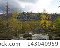 Granite cliff under a dark, dramatic sky. 143040959