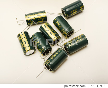 Green electrolytic capacitors on a white background. Electronic components. Charge storage devices. Green electrolytic capacitors on a white background. Electronic components. Charge storage devices. 143041918