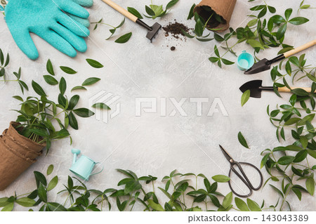 Gardening spring concept with green leaves and tools. Flat lay. Gardening spring concept with green leaves and tools. Flat lay. 143043389