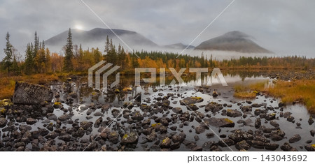 Panoramic view of wild taiga lake and misty mountains in autumn Panoramic view of wild taiga lake and misty mountains in autumn 143043692