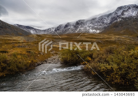 River ford in autumn mountain valley under blue sky River ford in autumn mountain valley under blue sky 143043693