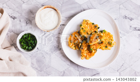 Fried "lazy" hand pies with boiled eggs and green onions on a plate on the table top view web banner Fried "lazy" hand pies with boiled eggs and green onions on a plate on the table top view web banner 143043802