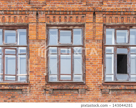 Three windows of the old mansion 19 century with brown bricks wall Three windows of the old mansion 19 century with brown bricks wall 143044281
