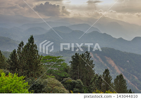 View from Ambuluwawa Tower, multi-religious temple complex located in Gampola, in Sri Lanka. Majestic Layers of Lush Mountains and Evergreen Trees Under a Dramatic Cloudy Sky View from Ambuluwawa Tower, multi-religious temple complex located in Gampola, in Sri Lanka. Majestic Layers of Lush Mountains and Evergreen Trees Under a Dramatic Cloudy Sky 143044810