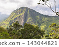 Ella rock mountain in Sri Lanka. Majestic Green Mountain Landscape Under a Partly Cloudy Sky, Featuring Lush Trees and Rugged Rock Formations, Natural Beauty 143044821