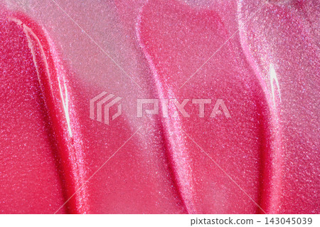 Pink glittery makeup texture creating an abstract art background with glossy swirls Pink glittery makeup texture creating an abstract art background with glossy swirls 143045039