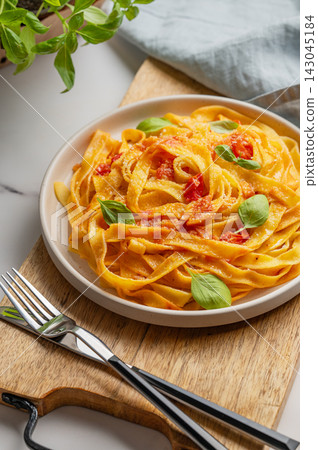 Homemade Tagliatelle Pasta with Tomato Sauce, Basil and Parmesan 143045184