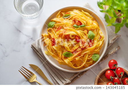 Homemade Tagliatelle Pasta with Tomato Sauce, Basil and Parmesan Homemade Tagliatelle Pasta with Tomato Sauce, Basil and Parmesan 143045185