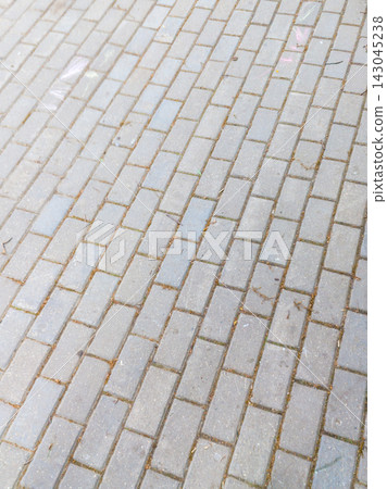 Rhythmic Grey Concrete Paving Slabs Texture on Urban Sidewalk Rhythmic Grey Concrete Paving Slabs Texture on Urban Sidewalk 143045238