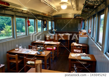 The train classroom associated with "Totto-chan at the Window" is beautifully illuminated by the greenery outside the window and the warm lighting. The train classroom associated with "Totto-chan at the Window" is beautifully illuminated by the greenery outside the window and the warm lighting. 143045242