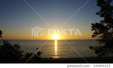 The beautiful light of the setting sun reflecting on the sea The beautiful light of the setting sun reflecting on the sea 143045315