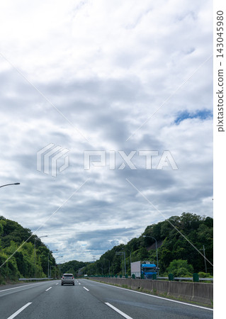Background image of a highway with a blue sky and clouds. Background image of a highway with a blue sky and clouds. 143045980