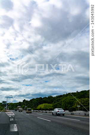 背景圖片為高速公路,天空湛藍,白雲朵朵。 背景圖片為高速公路,天空湛藍,白雲朵朵。 143045992