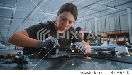 Technician Assembling FPV Drone Frame on Production Line In Modern Defense Manufacturing Facility Technician Assembling FPV Drone Frame on Production Line In Modern Defense Manufacturing Facility 143046798