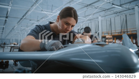 Engineer Integrating Electronic Boards In UAV Fuselage During High Precision Aircraft Manufacturing Engineer Integrating Electronic Boards In UAV Fuselage During High Precision Aircraft Manufacturing 143046829
