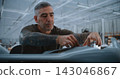 Professional Engineer Installs Electronic Components inside Unmanned Fixed Wing Aircraft 143046867