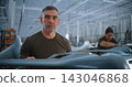 Portrait of Tattooed Male Engineer Looking at Camera in UAV Manufacturing Factory 143046868