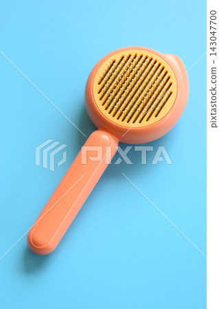 pastel orange comb on blue background, hair brush for pet pastel orange comb on blue background, hair brush for pet 143047700