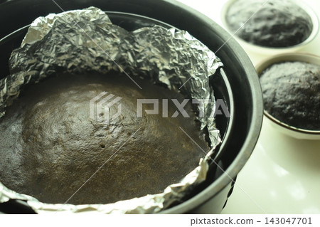 brown chocolate cake bake on aluminum foil paper 143047701