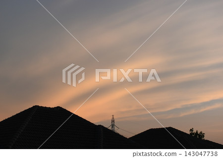roof of house on beautiful golden sky and white cloud background in springtime 143047738