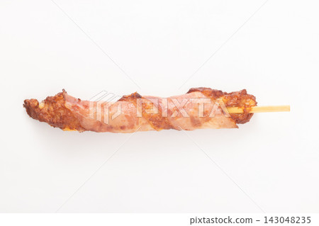 Cheese-filled fish cake wrapped in bacon, on a skewer. Cheese-filled fish cake wrapped in bacon, on a skewer. 143048235