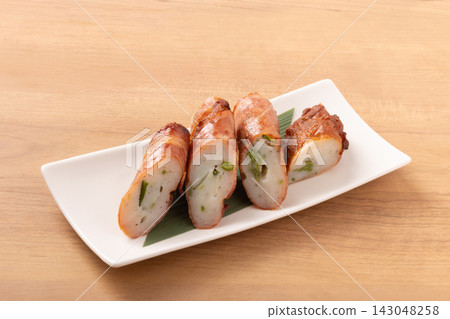 Asparagus fish cake wrapped in bacon Asparagus fish cake wrapped in bacon 143048258