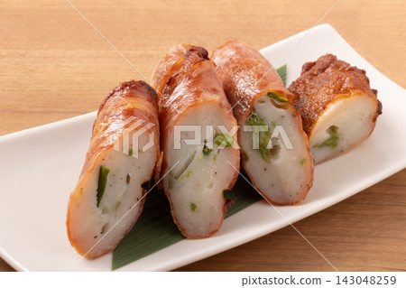 Asparagus fish cake wrapped in bacon Asparagus fish cake wrapped in bacon 143048259