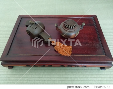 A magic mallet and incense burner on a display stand. A magic mallet and incense burner on a display stand. 143049282