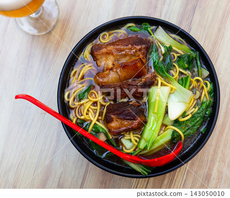 Hot soup with noodles and pork ribs top view Hot soup with noodles and pork ribs top view 143050010