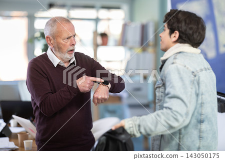 Upset guy employee of company quits job, and mature manager shouts after him. Upset guy employee of company quits job, and mature manager shouts after him. 143050175