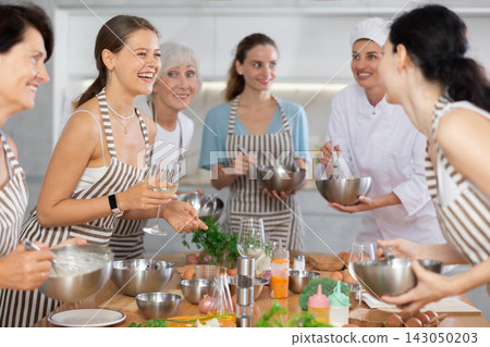 Young woman talks and drinks with group during master class 143050203