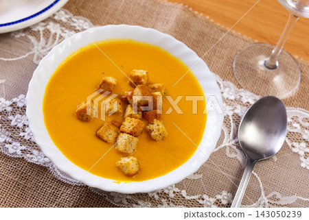 Creamy zucchini soup served with croutons Creamy zucchini soup served with croutons 143050239
