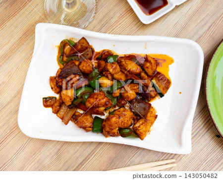 Tasty chicken pieces in in satay sauce with stewed eggplant and peppers Tasty chicken pieces in in satay sauce with stewed eggplant and peppers 143050482