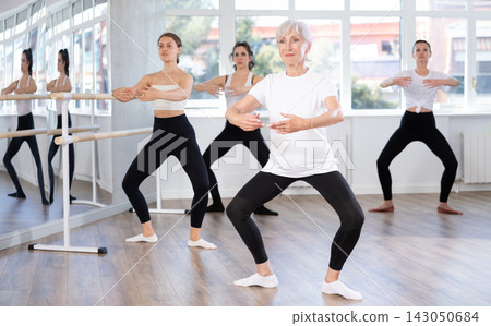 Group of women rehearsing ballet dance Group of women rehearsing ballet dance 143050684