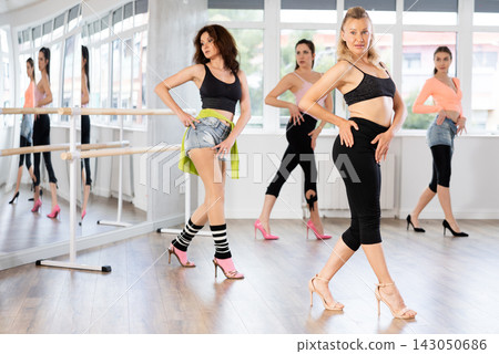 Group of women dancing high heels in studio Group of women dancing high heels in studio 143050686