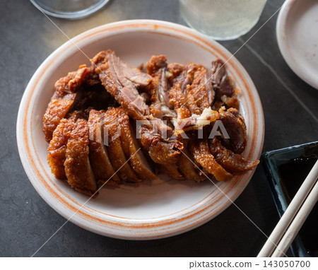 Appetizing pieces of baked duck breast are served with spicy sauce and decorated with white sesame seeds Appetizing pieces of baked duck breast are served with spicy sauce and decorated with white sesame seeds 143050700