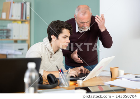 Mature male manager is dissatisfied with the work of an employee - yells and reproaches her Mature male manager is dissatisfied with the work of an employee - yells and reproaches her 143050704