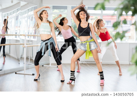 Group of women dancing high heels in studio 143050705