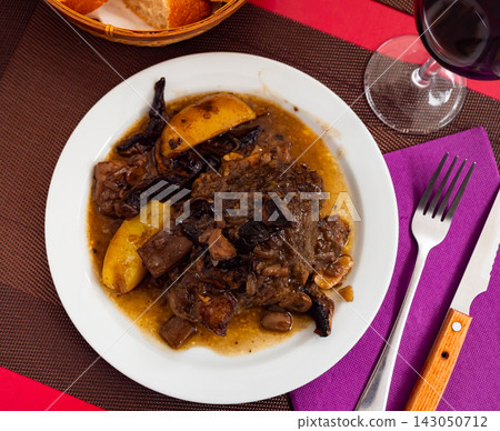 Stew made with pork meat, potatoes, and mushrooms in thick gravy. Stew made with pork meat, potatoes, and mushrooms in thick gravy. 143050712