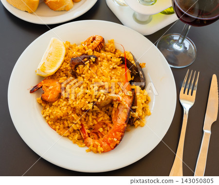 Traditional Spanish paella on a white plate 143050805
