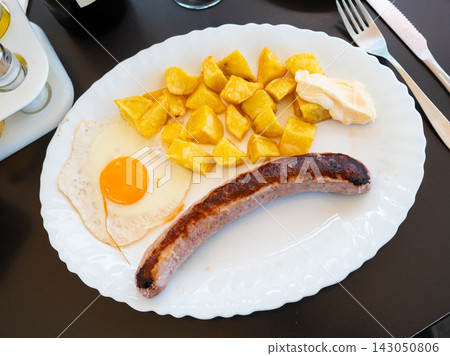 Fried Butifarra sausage with potatoes and eggs 143050806
