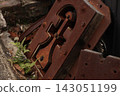 Rusty parts lying on the side of the road 143051199