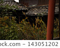 A house overgrown with grass 143051202
