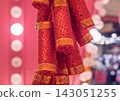 Decorative red firecrackers with shining sequins and gold bands for a vibrant holiday celebration 143051255