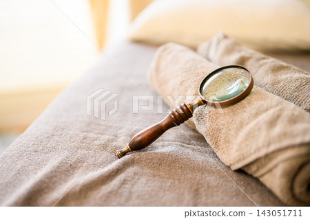 Research image using a magnifying glass on a towel Research image using a magnifying glass on a towel 143051711