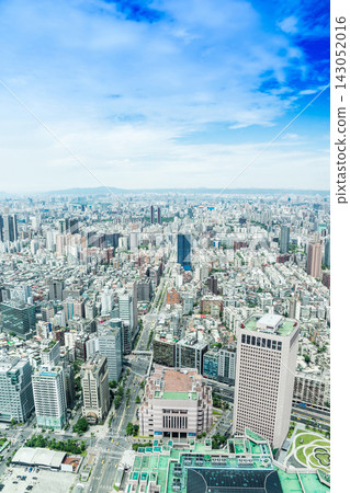 Panoramic aerial view of cityscape, skyline and urban sprawl of Taipei in Taiwan under sun, bright blue sky 143052016