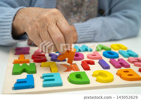 Asian elderly woman playing game. Asian elderly woman playing game. 143052629