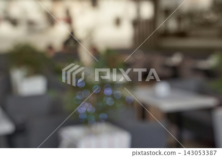 Cafe Seating Area Shown Out Of Focus With Bokeh Lights And Tabletop Elements In Shallow Depth Cafe Seating Area Shown Out Of Focus With Bokeh Lights And Tabletop Elements In Shallow Depth 143053387