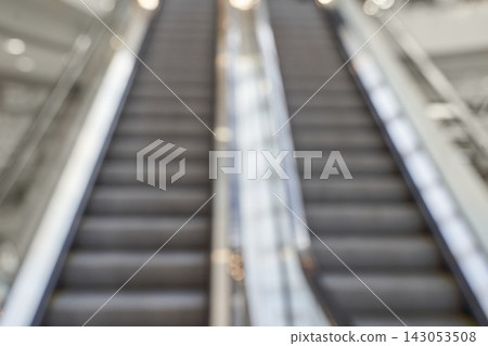 Escalator Slightly Blurred Rising In Indoor Commercial Atrium With Visible Handrails And Shallow Escalator Slightly Blurred Rising In Indoor Commercial Atrium With Visible Handrails And Shallow 143053508
