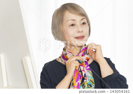 Senior women choosing scarves to dress stylishly Senior women choosing scarves to dress stylishly 143054161